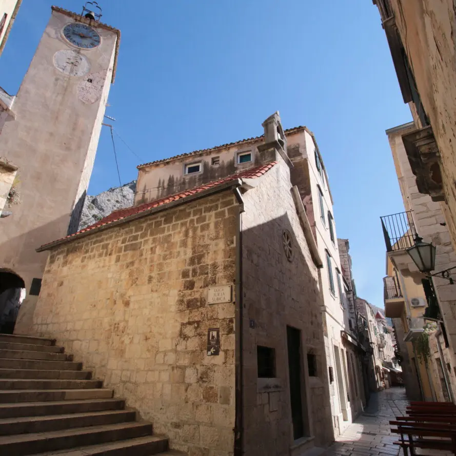 Stone Church of St Rocco in a narrow Omiš old-town lane